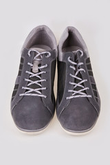 Pair of new modern grey stylish sneakers for men isolated on white background