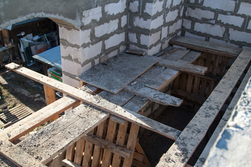interior of a country house under construction. Site on which the walls are built of gas concrete blocks with wooden formwork