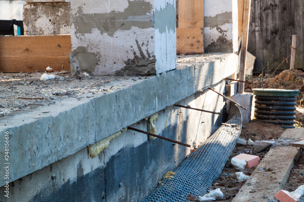 Poster inspection manhole and concrete foundation porches with supporting columns of foam blocks on the per