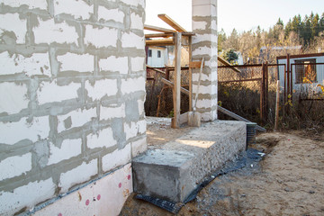 inspection manhole and concrete foundation porches with supporting columns of foam blocks on the perimeter