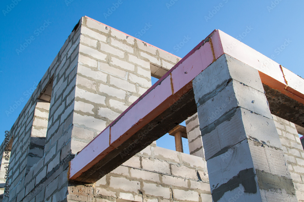 Poster close-up view of the docking concrete beam with a wooden log to the foam block wall of a country cot