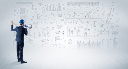 Engineer with construction helmet holding a plan and standing with graphs, charts and reports on the background