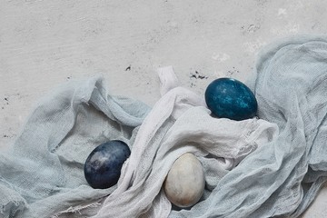 Dyed Easter vintage eggs with scuffs on a light gray background. Stylish Background with easter...