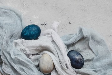 Dyed Easter vintage eggs with scuffs on a light gray background. Stylish Background with easter...