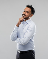 business, office worker and people concept - smiling indian businessman in shirt over grey background