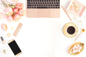 Flat lay of female white office table desk with laptop, bouquet of roses, cup of coffee. Top view of home office workspace. Women's gold and pink fashion accessories isolated on white background.