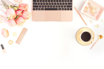 Flat lay of woman home workspace with laptop, cup of coffee, cosmetics, roses flowers. Top view, copyspace on white background