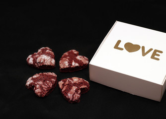 red chocolate cracked heart-shaped cookies with a white box. A gift for Valentine's Day, World Women's Day or Birthday