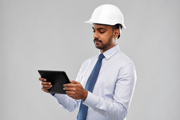 architecture, technology, construction business and building - indian architect or businessman in helmet with tablet computer over grey background