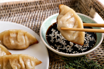 Eating of tasty Japanese gyoza, closeup