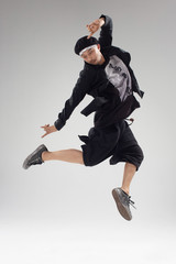 Hip hop dancers moving and jumping in photostudio