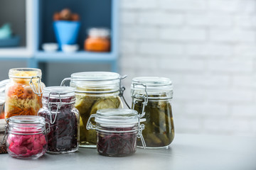 Assortment of tasty fermented vegetables on table in kitchen