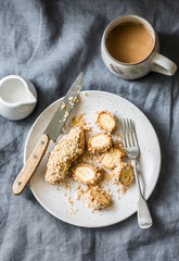 Healthy protein snack, breakfast - peanut butter, seeds, banana nut bites on a grey background, top view