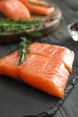 Raw salmon fillet on slate board, closeup