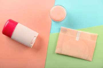Items for personal hygiene on color background