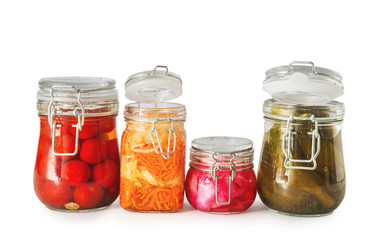 Fototapeta na wymiar Jars with tasty fermented vegetables on white background