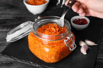 Eating of tasty fermented carrot, closeup