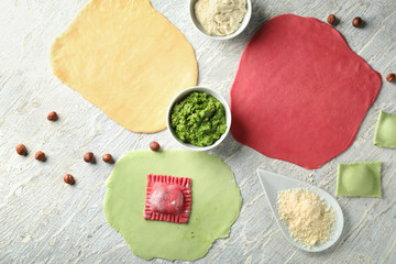 Preparing of tasty ravioli on light table