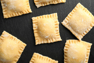 Uncooked ravioli on dark background