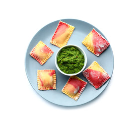 Uncooked ravioli with spinach filling on white background