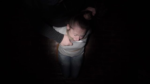 Hands Killer Bring Knife To Neck Of Tied Woman To Chair. Top View.