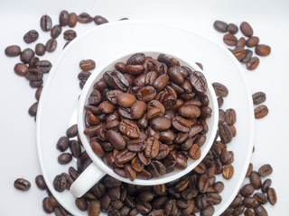 Coffee beans in coffee cup isolated on white