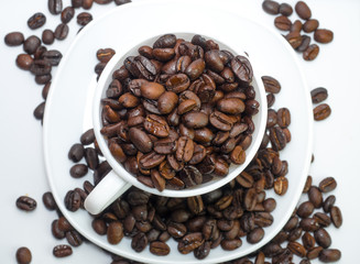 Coffee beans in coffee cup isolated on white