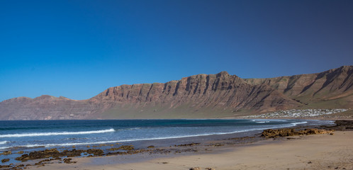 Fototapeta na wymiar Panorama of Famara beach, an important surf area in Lanzarote, Canary Islands