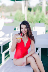 Portrait of relaxing happy woman with glass of cocktail