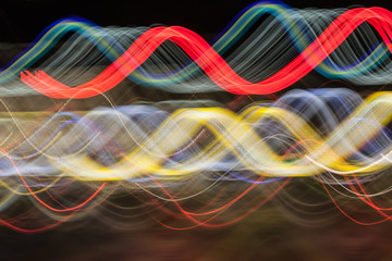 Abstract blurred colorful light effect on a black background. Long exposure photo of moving camera