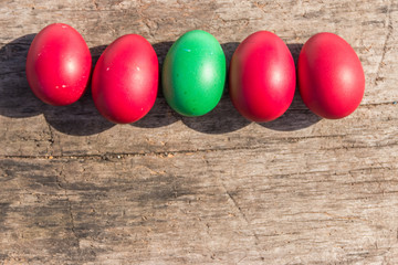 Painted Easter eggs on rustic wooden background