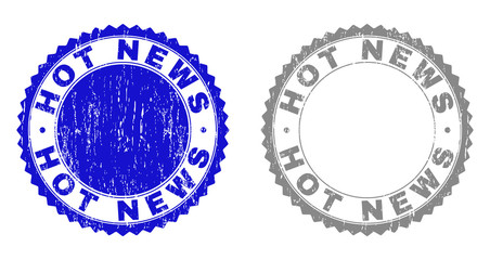 Grunge HOT NEWS stamp seals isolated on a white background. Rosette seals with distress texture in blue and gray colors. Vector rubber stamp imitation of HOT NEWS tag inside round rosette.