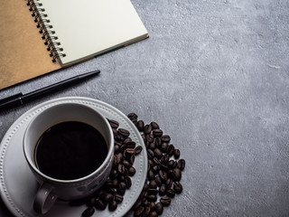 Coffee cup and coffee beans on table