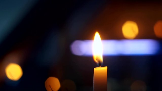 burning candle flame on black background close up