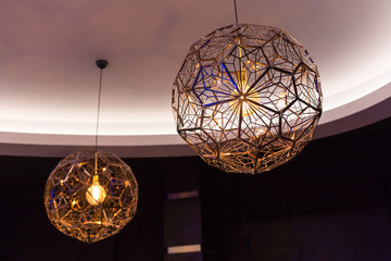 Two round modern chandeliers.