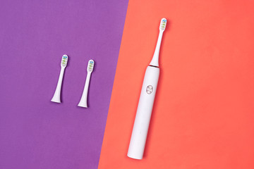 Smart electric toothbrush. Controlled by the application on the smartphone. Modern technology for health. Healthy teeth. Dentistry. Purple and pink paper background