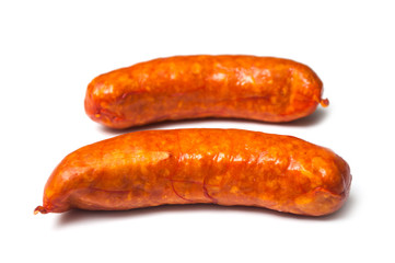 Closeup of smoked sausage on white background