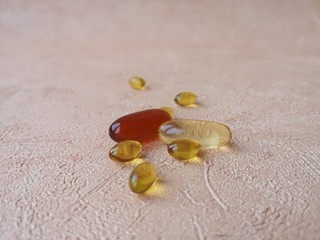 Fototapeta na wymiar Close-up: different capsules (pills, tablets) on a light orange background