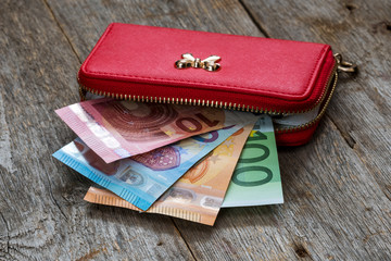 Red female wallet with Euro cash