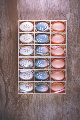 Easter eggs hand painted inside a gift box, photo for advertising use.