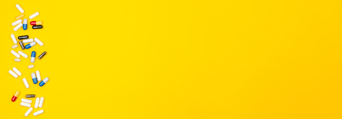 Pills or drugs spilled on a colored background