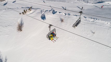 Skiers on skilift view from above. Ski resort in Europe