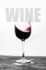 Red wine in the glass splashes in motion on a white background. Design drink card with text