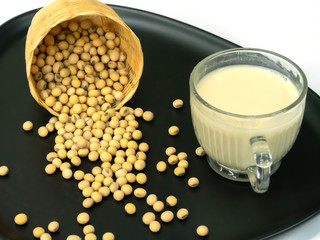 Soy milk and soybeans in a plate, Isolated on white background