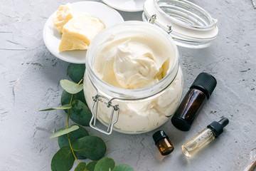 diy body butter with ingrdients on concrete background