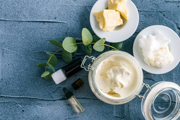 diy body butter with ingrdients on concrete background