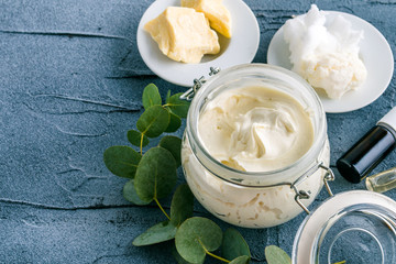 diy body butter with ingrdients on concrete background