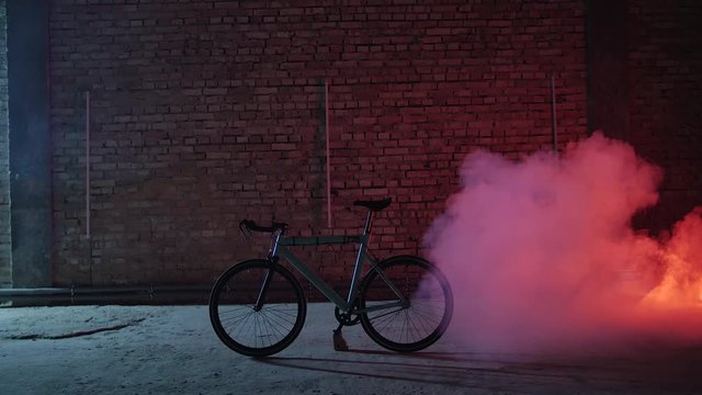 4K The portrait of the bicycle standing in the garage which is covered with the smoke