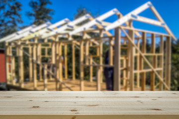Obraz premium Empty table top for product display montage. House construction, framework blurred in the background.