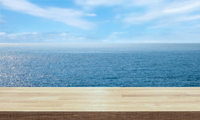Empty table top for product display montage. Horizon and endless ocean blurred in the background.